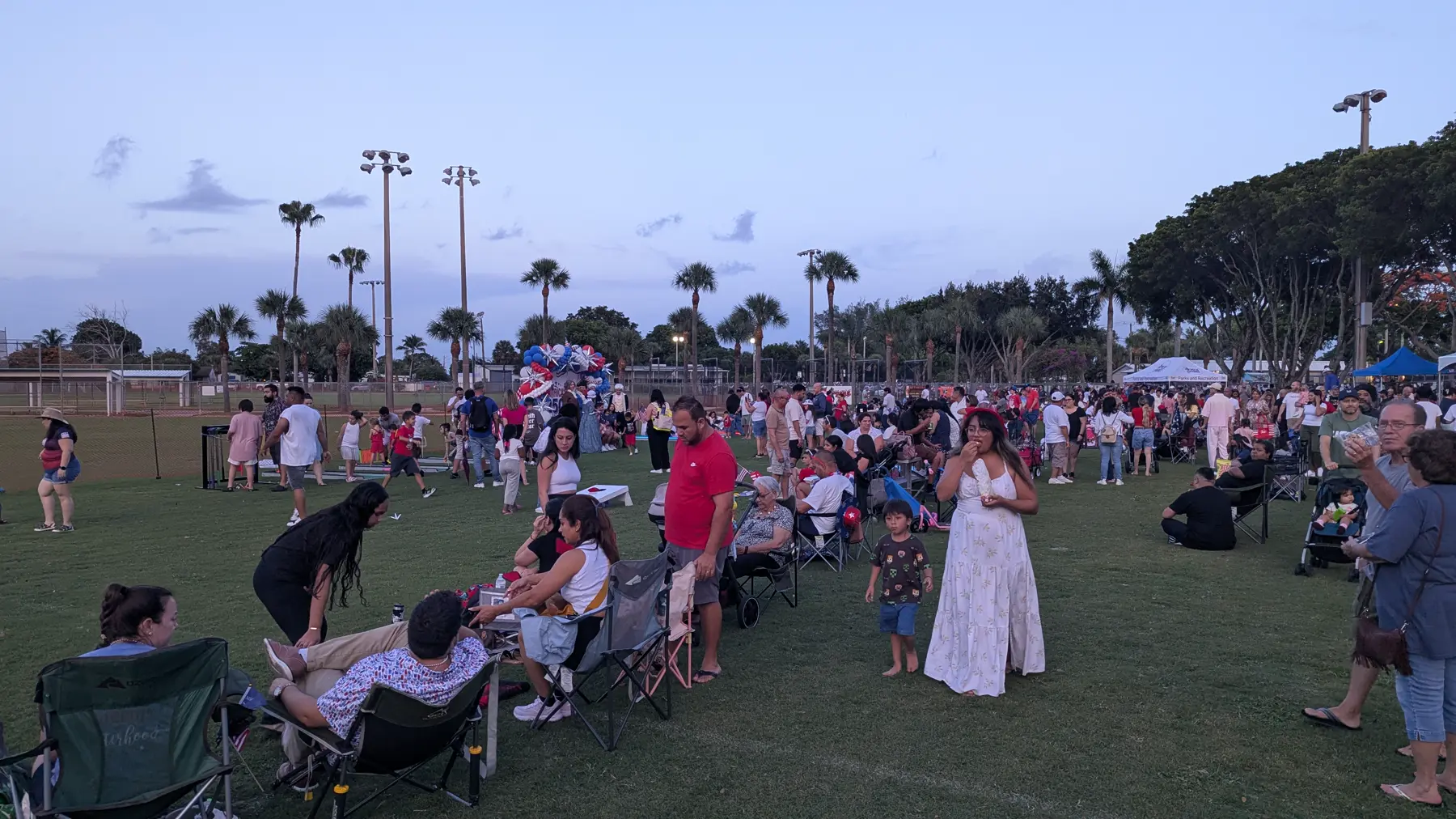 Families seated on blankets during the Village of Palm Springs 4th of July