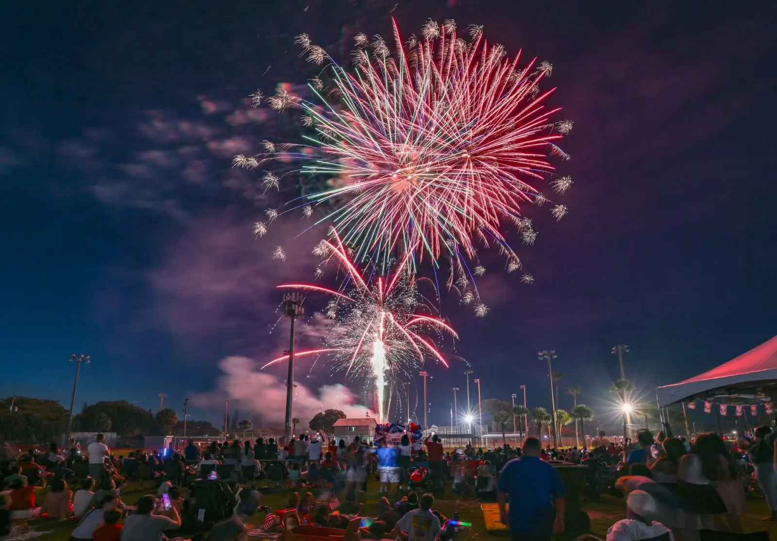 Red fireworks burst overhead at the Village of Palm Springs 4th of July celebration