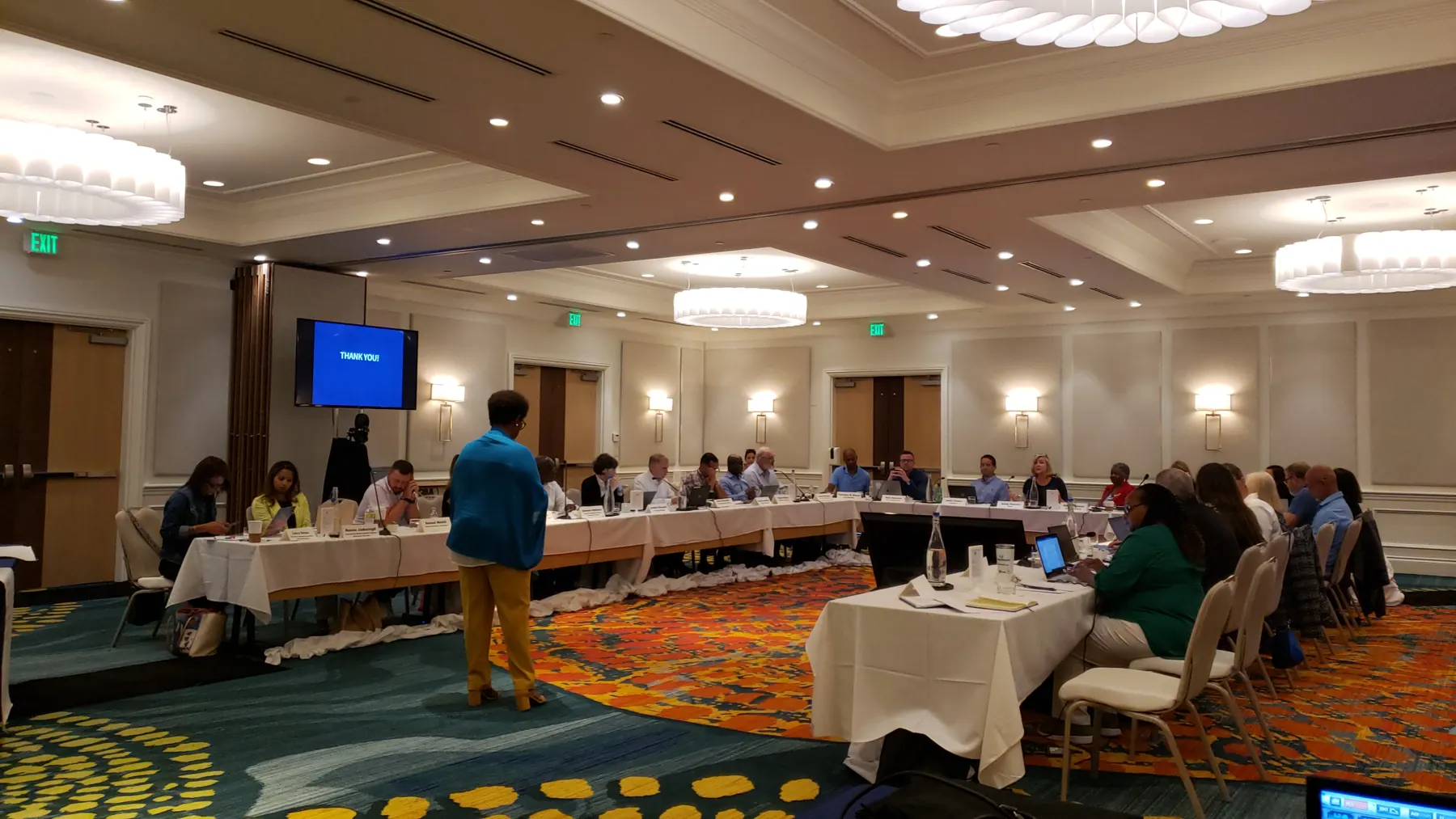 Facilitator and U-shaped tables with display monitors at the Delray Beach Goal Setting Workshop