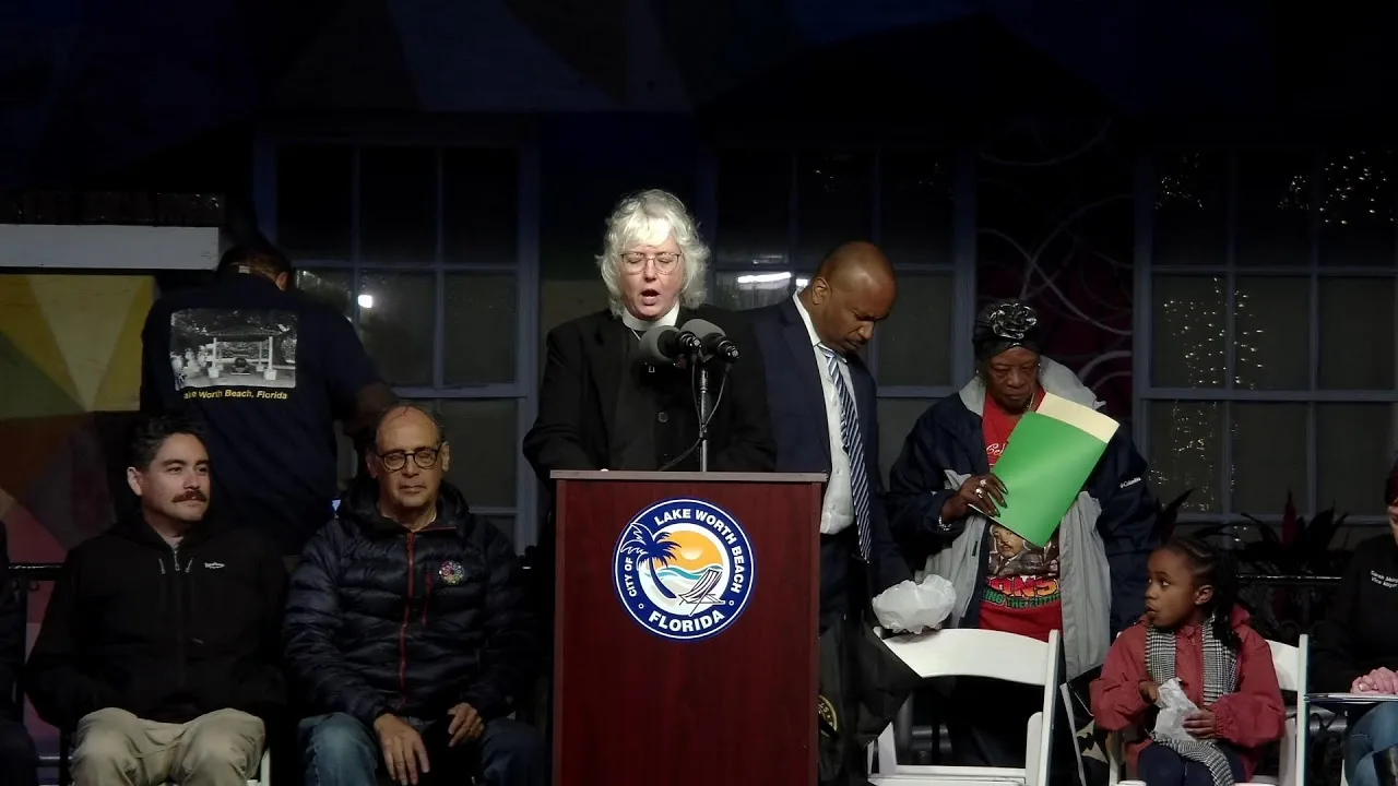 Speaker at the City of Lake Worth Beach podium with dignitaries seated behind her at the 31st Annual Dr. Martin Luther King, Jr. Celebration