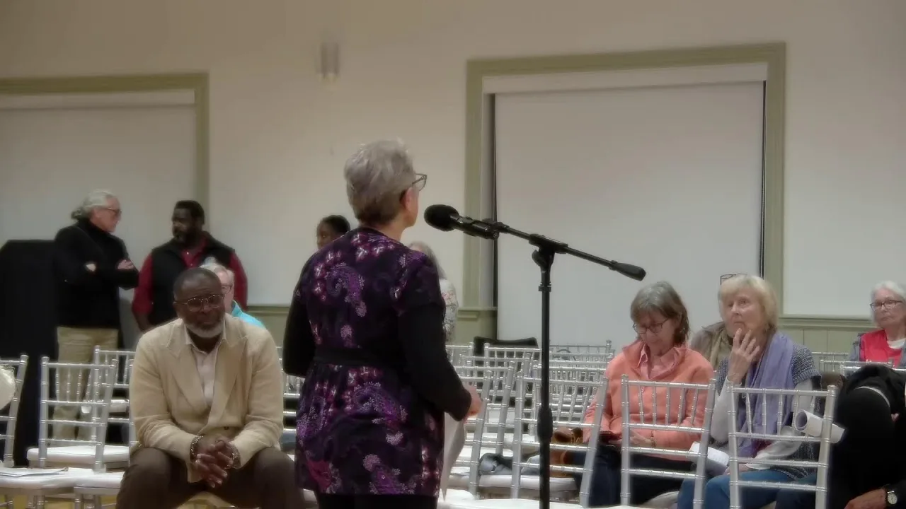 A resident asks a question at a floor microphone during the Lake Worth Beach Referendum Town Hall