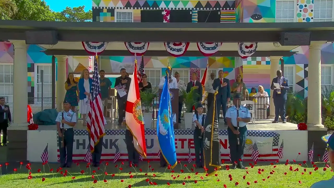 Color guard and city officials on the outdoor stage at the City of Lake Worth Beach 2023 Veterans Day Program