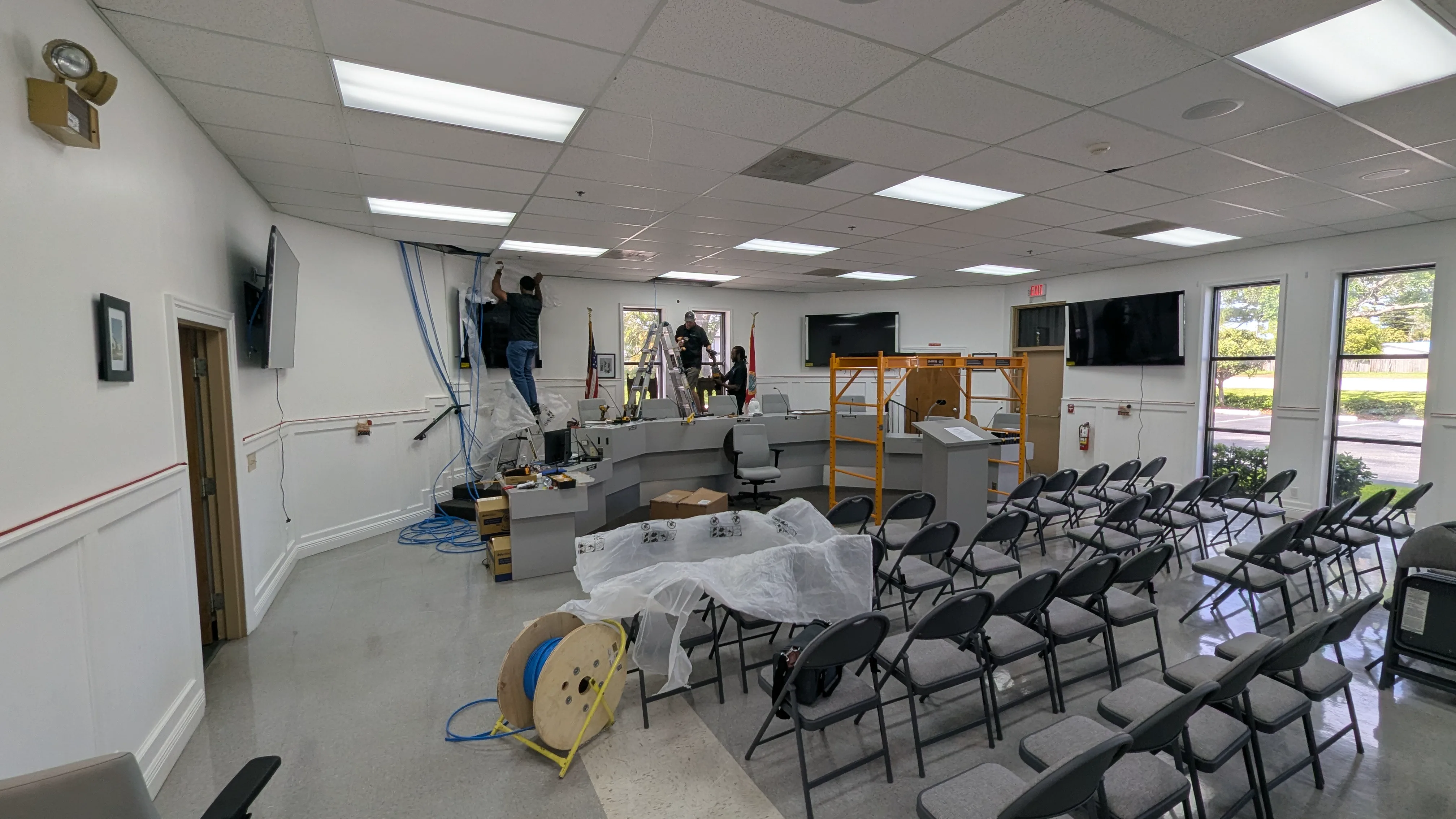 Technicians installing cabling and broadcast equipment in the Town of Mangonia Park Commission Chambers