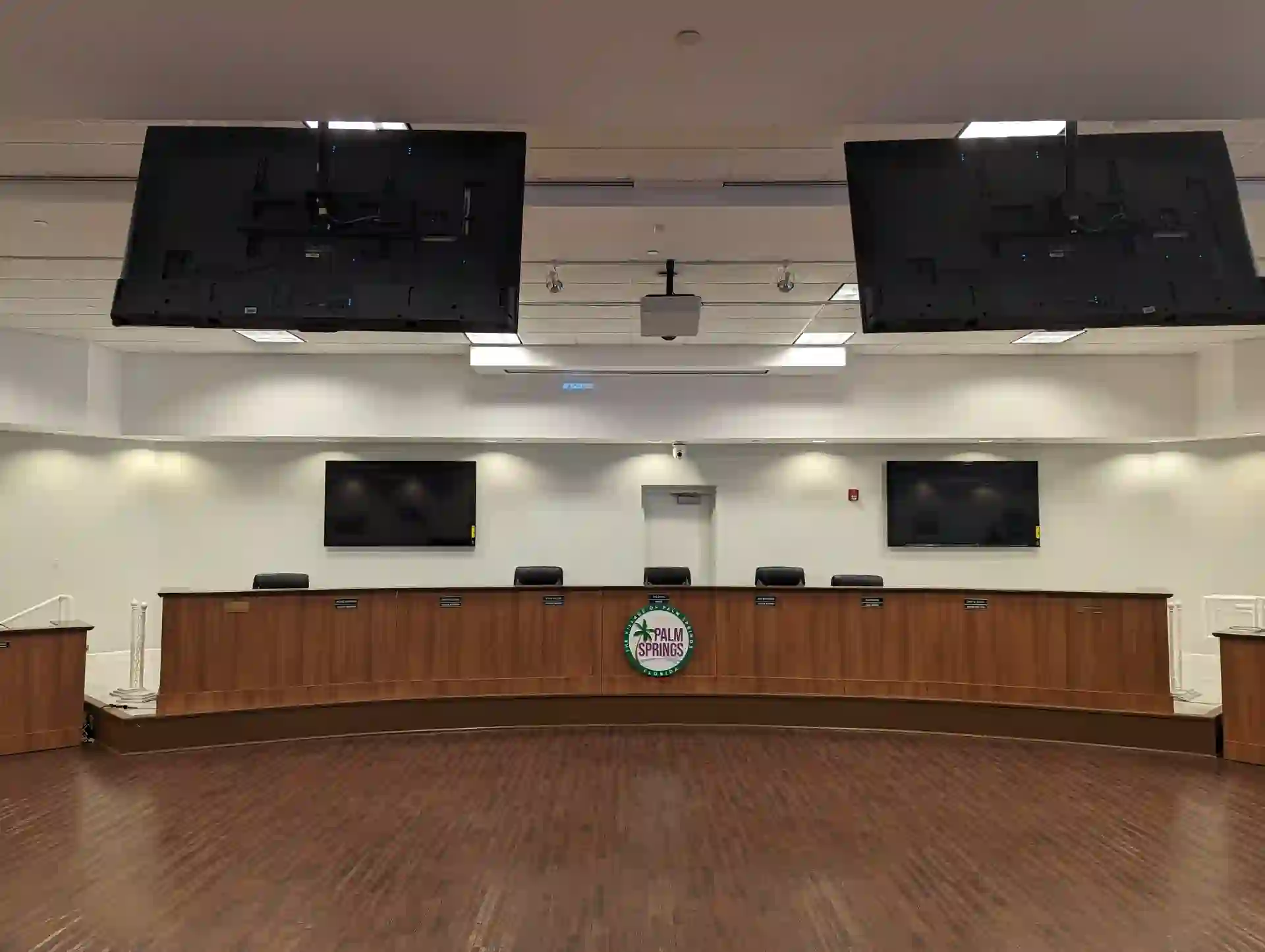 Wide view of the Village of Palm Springs Commission Chambers with two Sony 85-inch displays behind the dais
